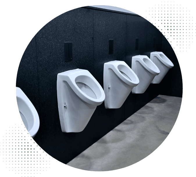 A row of white urinals mounted to the side of a wall.