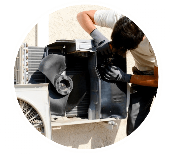 A man working on an air conditioner outside.